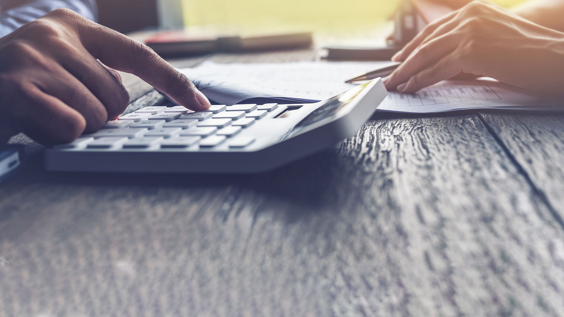 Hand operating a calculator.